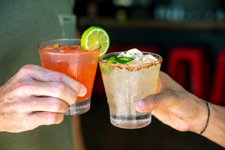 Photo of two cocktails toasting