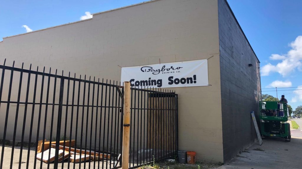 Photo of brewery with "Coming Soon" banner on the outside
