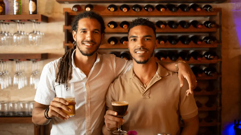 Photo of two brothers standing behind a bar