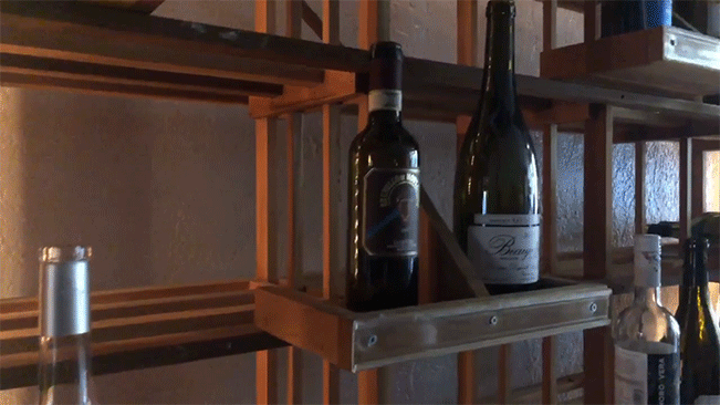 Bottles of wine on ascending shelves