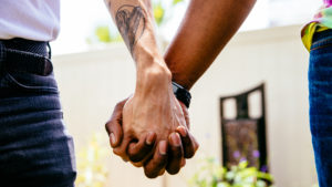 Two people holding hands