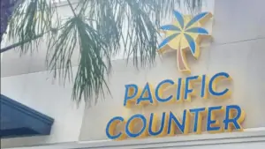 Exterior of a poke bowl restaurant with a sign reading Pacific Counter