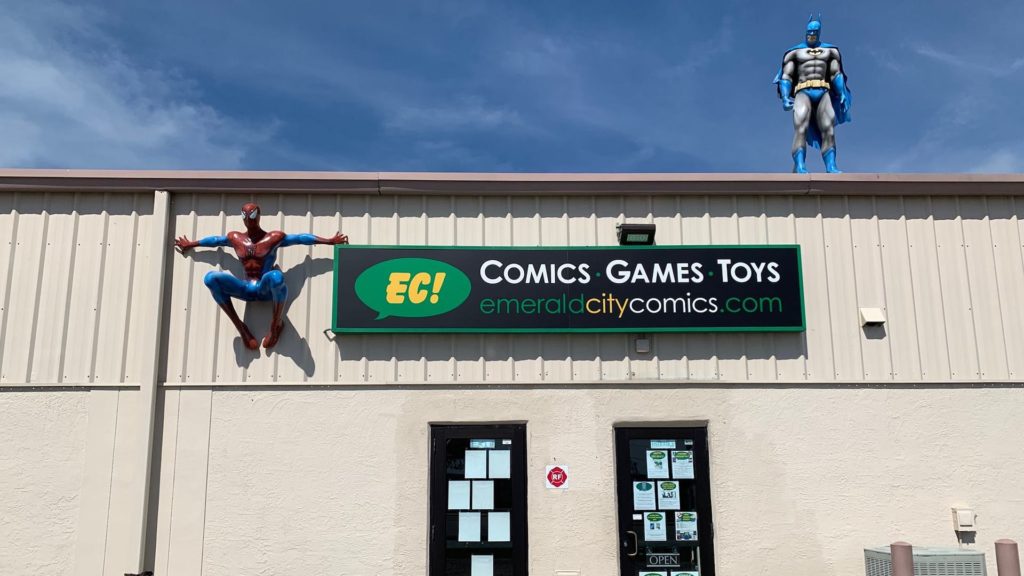 Exterior of a comic book shop with spider-man and batman