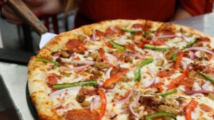 Photo of cheese pizza served at a bar