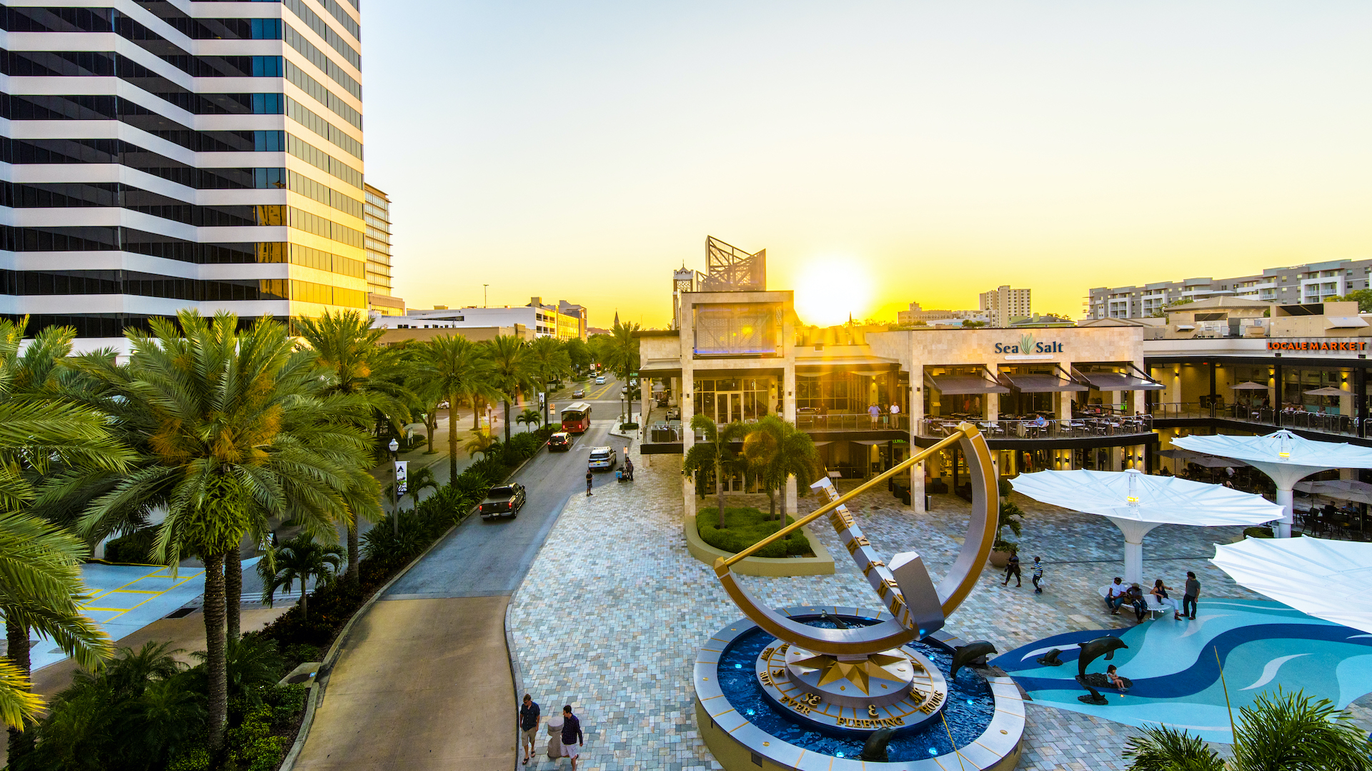 Photo of a sunrise over a shopping plaza with a giant sundial at the center