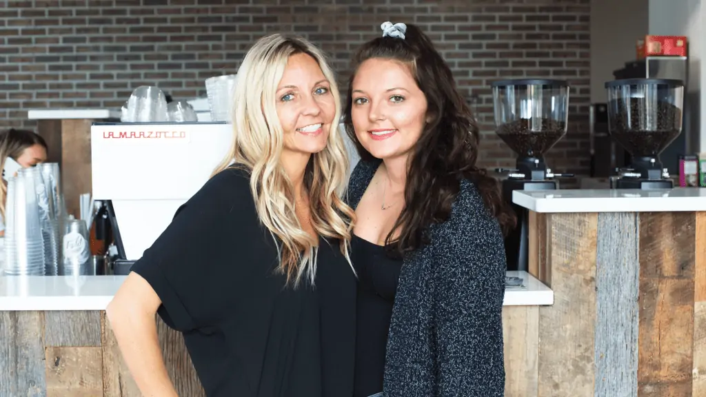 A mother and daughter stand inside their newly opened coffee shop