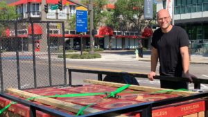 Photo of Dave Benstock, local chef, in front of a large donation of tomatoes