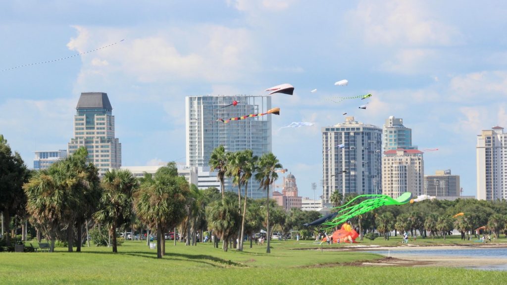Photo of kites flying over a waterfront park