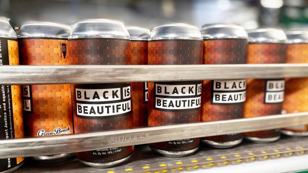 Photo of beer cans with a label that says "black is beautiful"