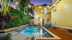 Photo of an infinity pool and a brick porch