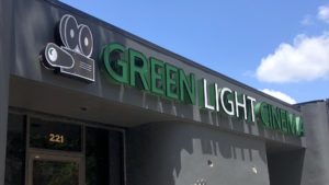 Exterior of St. Petersburg's Indie Movie Theatre, with a "Green Light St. Pete" sign