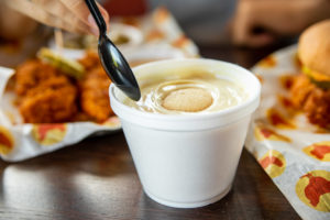 A spoon about to dip into the Banana puddin' from Joella's Hot Chicken