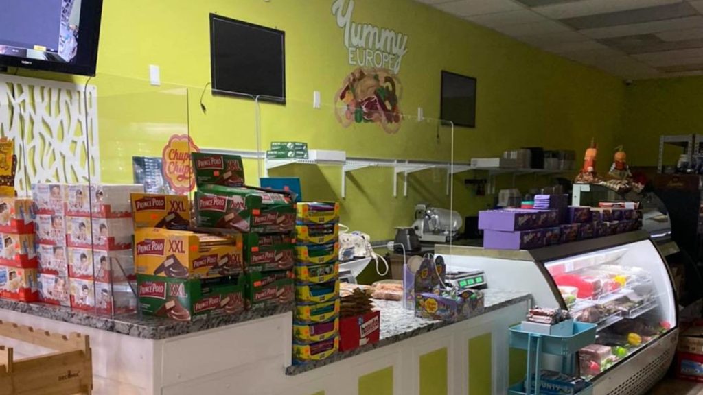 Inside a Eurpoean grocery store, with various cookies and chocolate bars on the counter