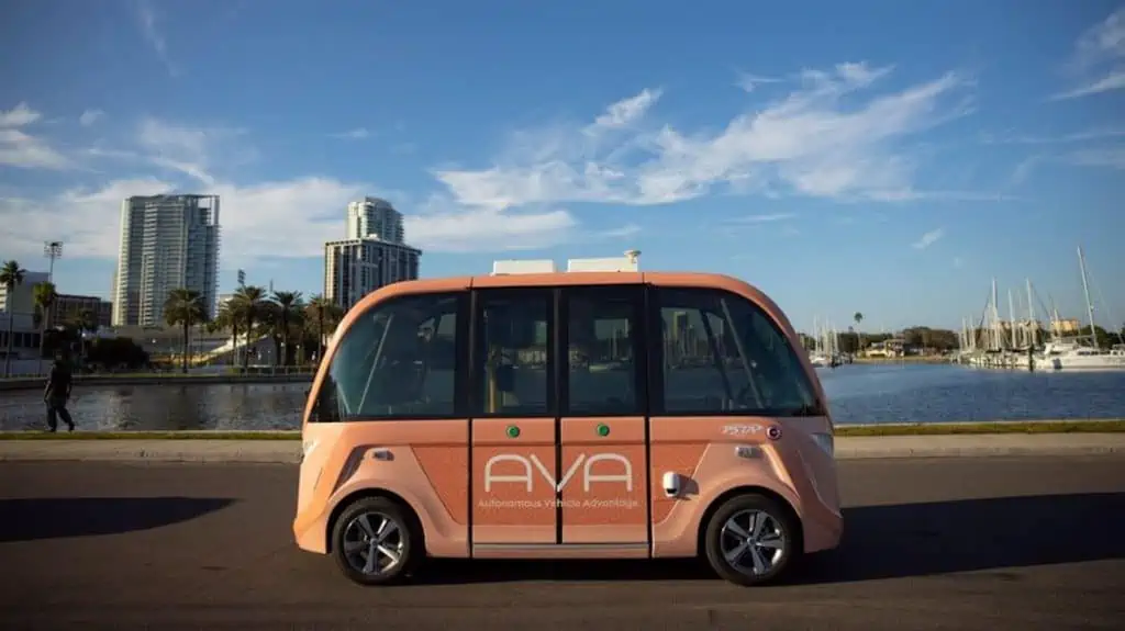 Image of a light orange self-driving car on the waterfront