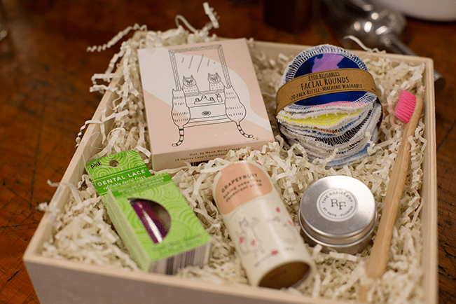 Assorted eco-friendly bath and kitchen products in a wooden box