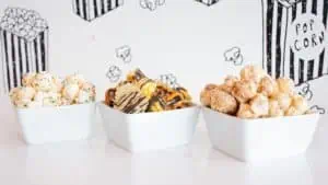 Image of three different gourmet popcorns in white bowls