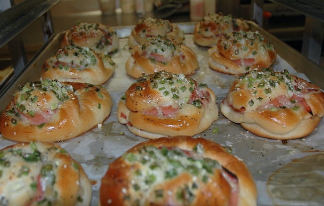 Assortment of fresh baked ham buns at a grocery store