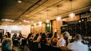 interior of a wine bar with Edison bulbs lit above the bar