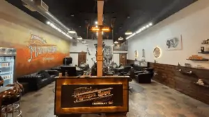 Inside a barbershop with a lion mural in the back