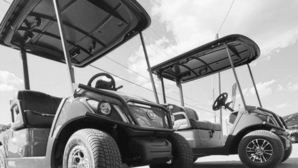 two golf carts parked next to each other