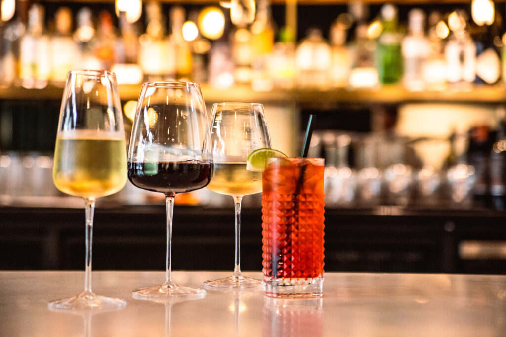Assortment of red and white wine in tall glasses on a marble bar