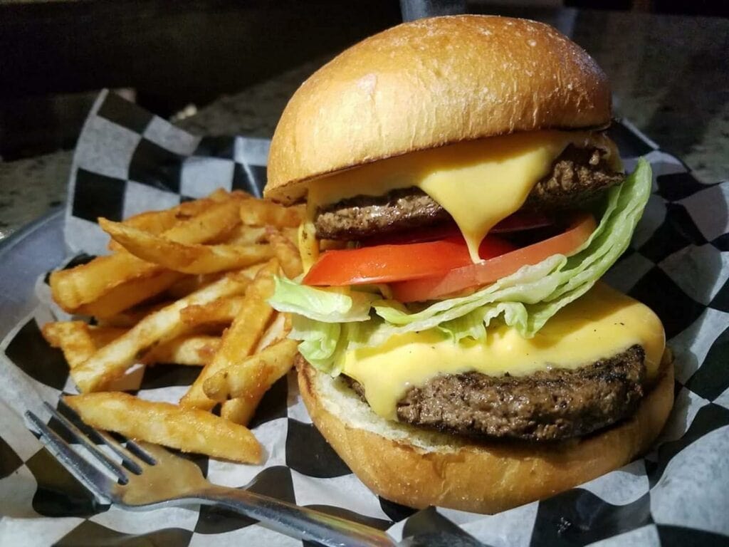 double cheeseburger plated with fries