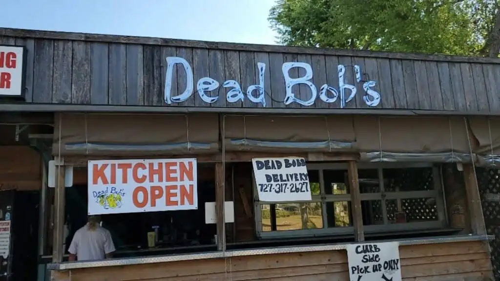 exterior of a burger joint with a blue neon sign that reads Dead Bob's