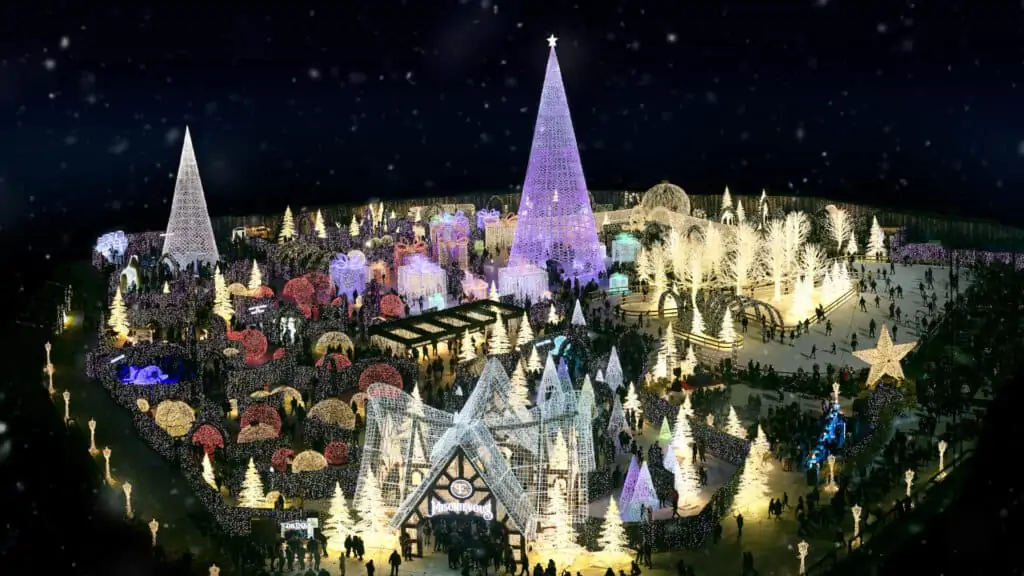 aerial view of a lit up Christmas Village with a light maze at the center