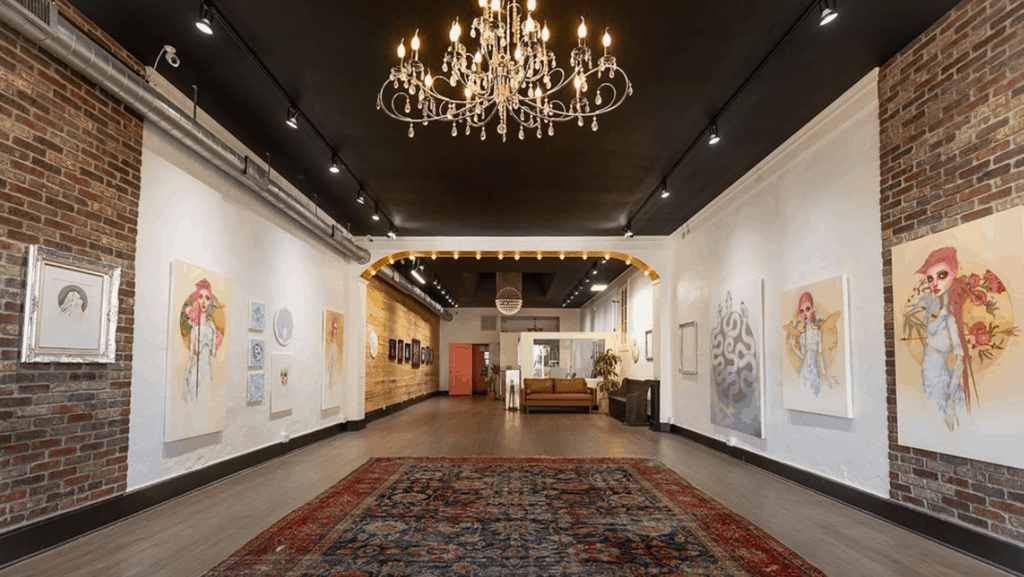 art gallery with a large red carpet at the center and hardwood floors