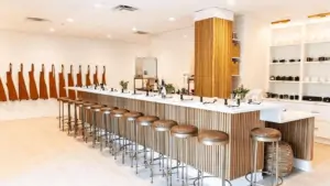 inside a candle shop with a large white bar and bar stools