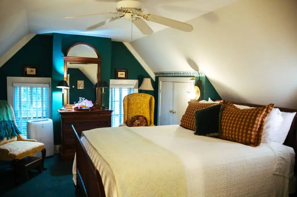 a bedroom with green walls and a large bed