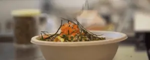 A picture of an Island Fin Poke bowl being filled with toppings