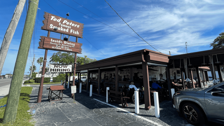 exterior of a restaurant with a large brown sign overhead