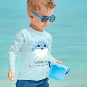 picture of a child in a light blue shirt with a shark on it