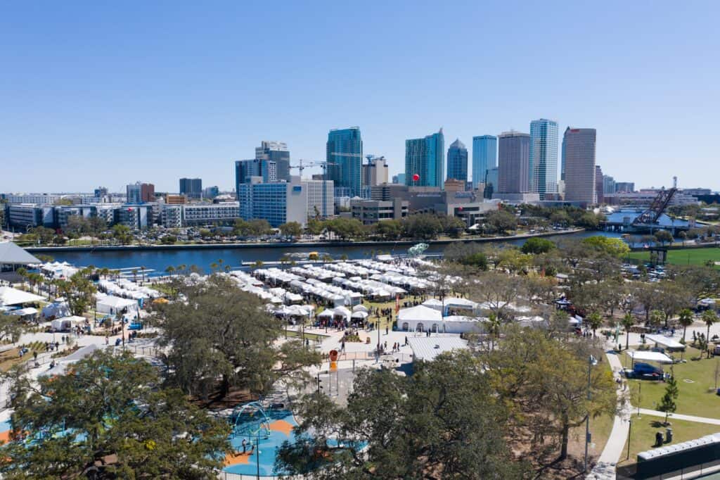 Skyline view of Tampa with hundreds of market tents on the river
