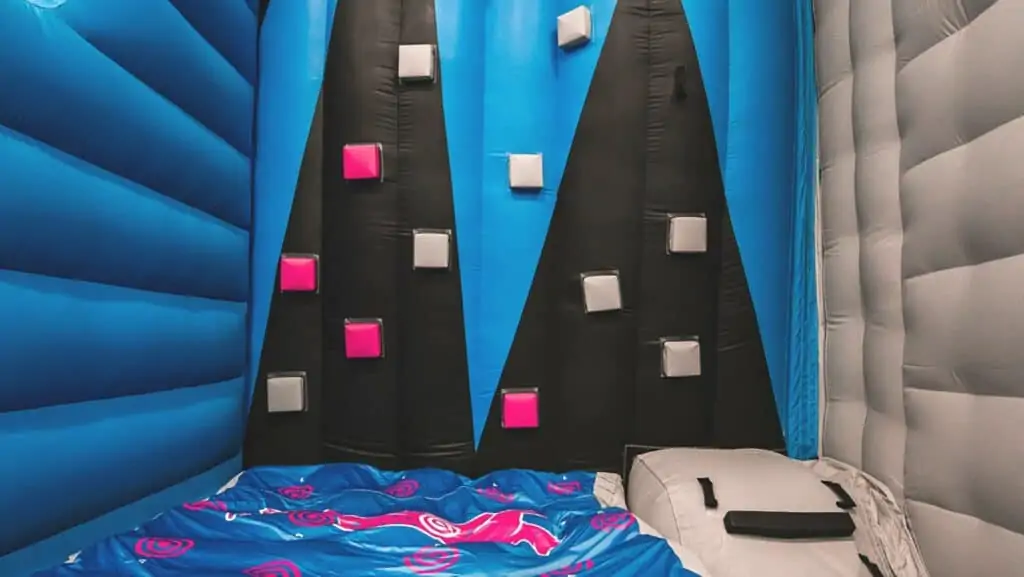 a free climb wall with a blue and black pattern