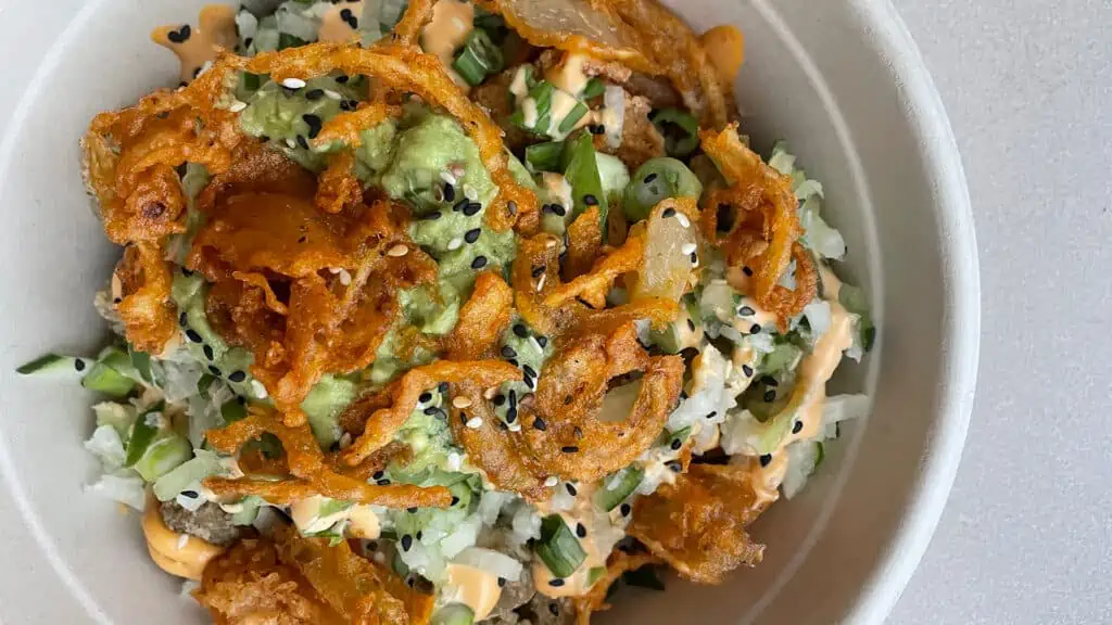 bowl with crispy tempura onions, avocado, sticky rice and more from Cali