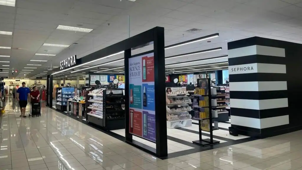 Exterior of a makeup shop inside of a department store with black and white tiling
