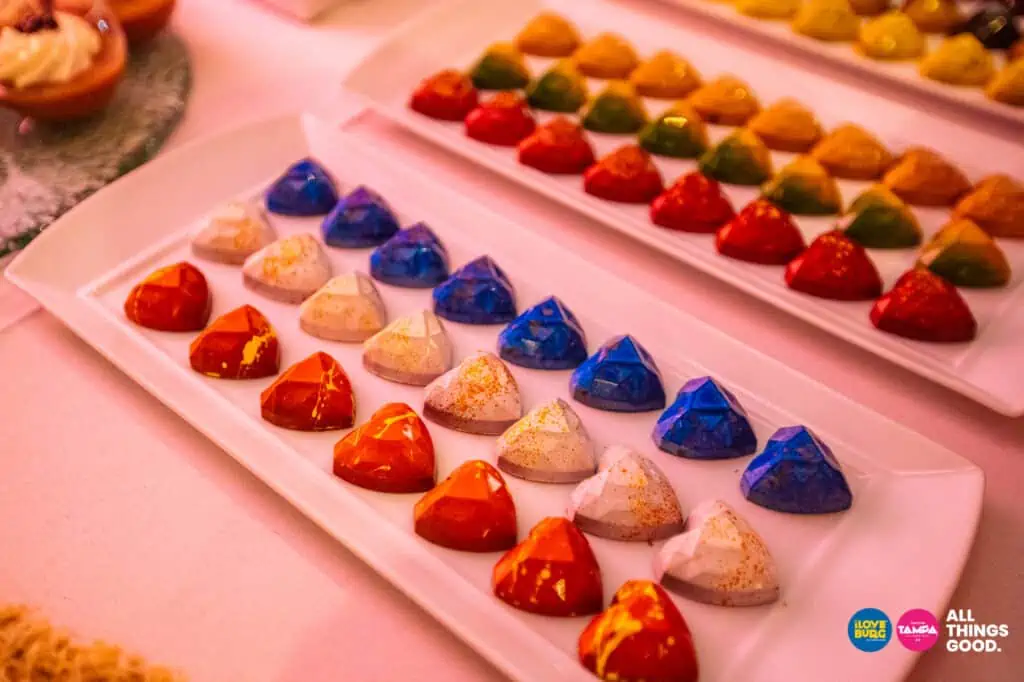 multicolored chocolate truffles in the shape of hearts on a plate