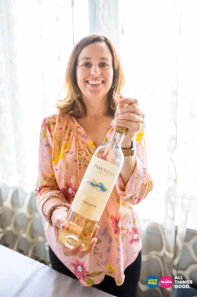 a woman holds a bottle of rosé