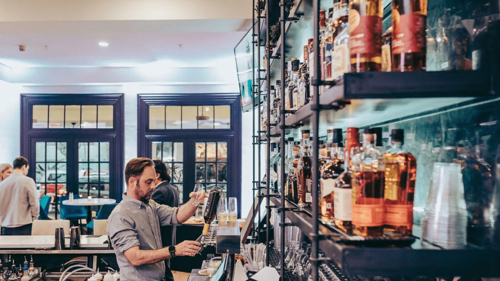 A bartender behind The Exchange bar