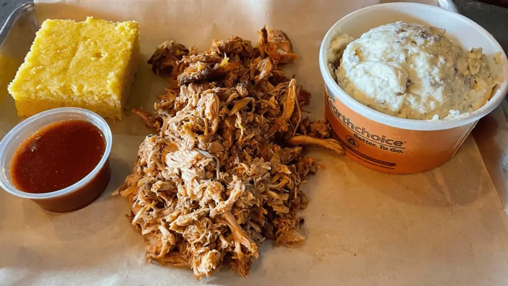 Cornbread, pulled pork and mashed potatoes on a plate