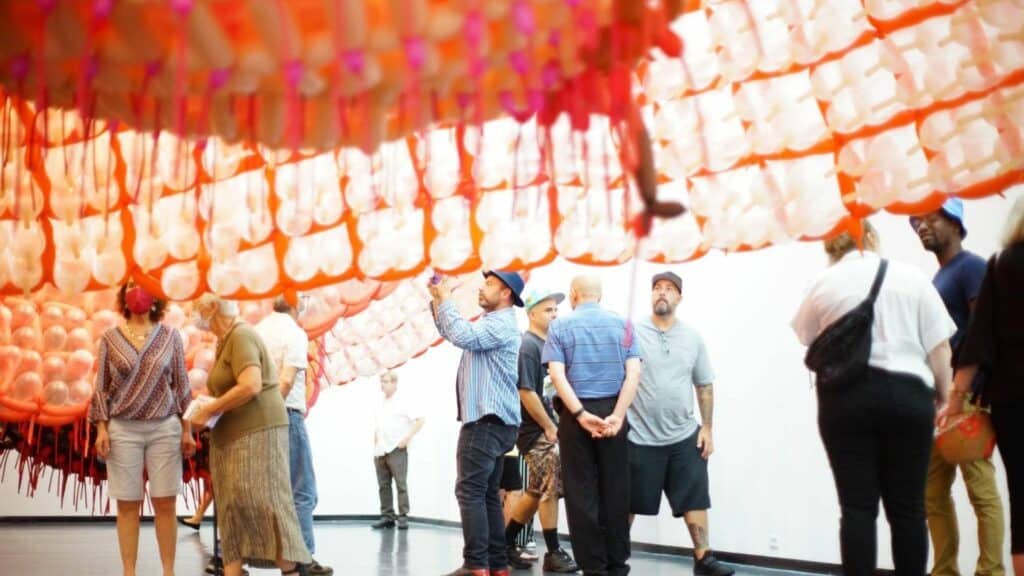 Attendees examining a balloon sculpture