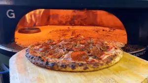 A pizza being taken from the oven at Nino's