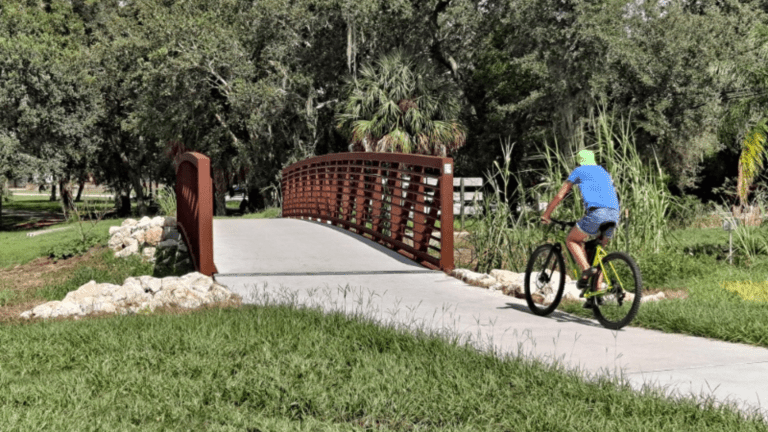 A biker on the Pinellas Trail crossing a bridge