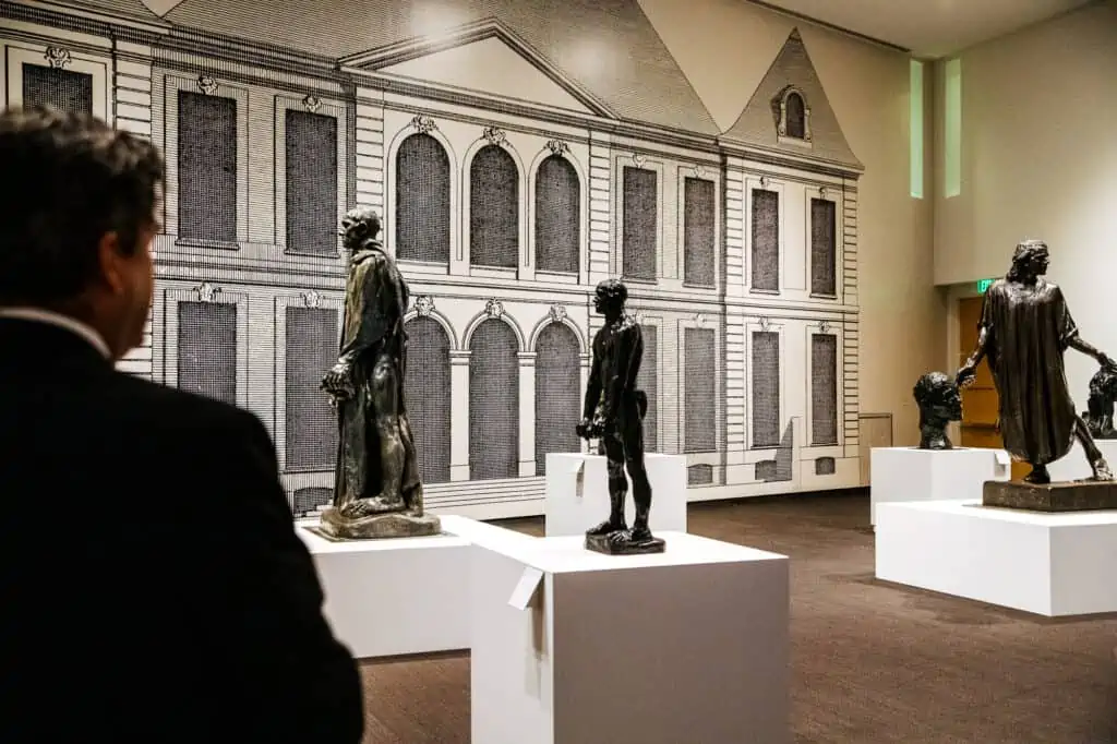 The curator looks at the Burghers of Calais sculptures by Rodin