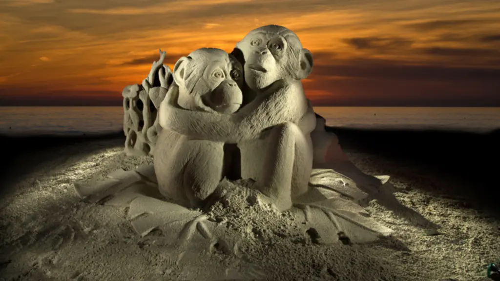 A sand sculpture of two monkeys