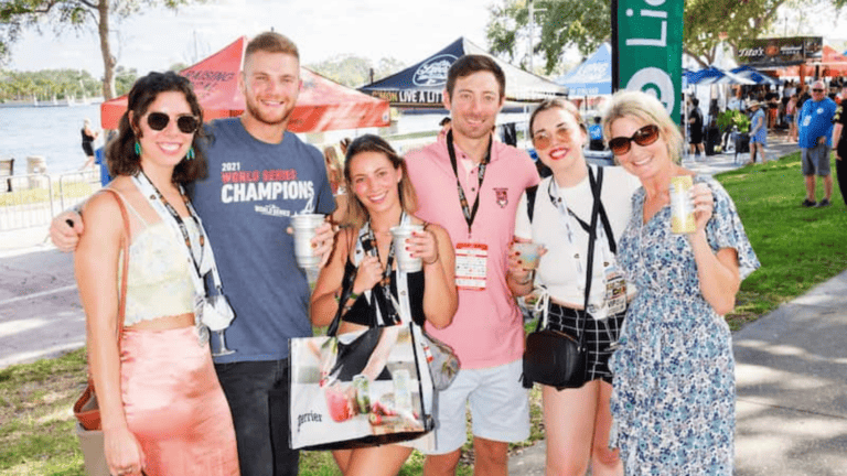 People posing for a picture at an outdoor festival