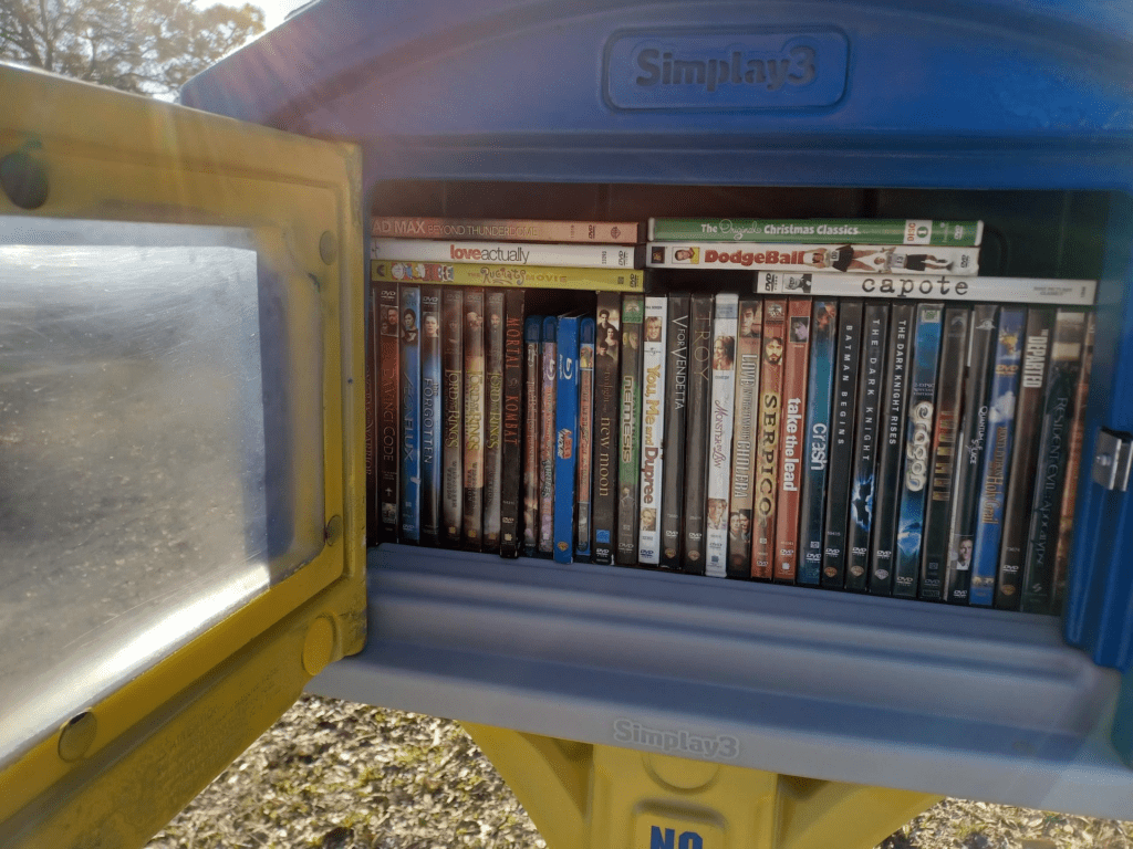 Inside a little free blockbuster. The blue and yellow box is filled with various DVDs