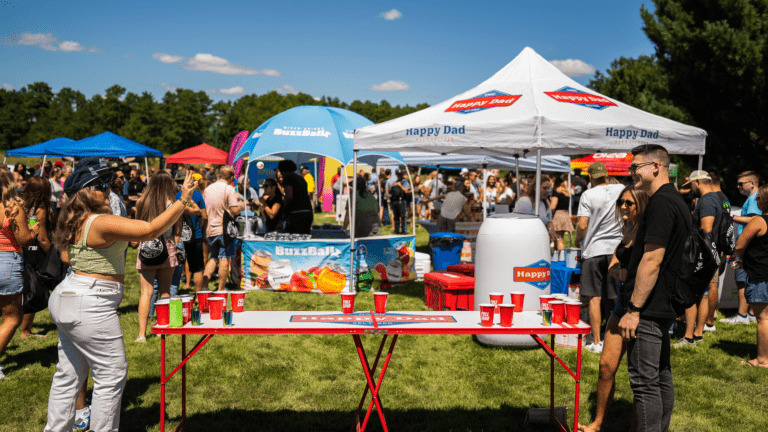 A large outdoor festival with vendor tents and mobile bars set up.